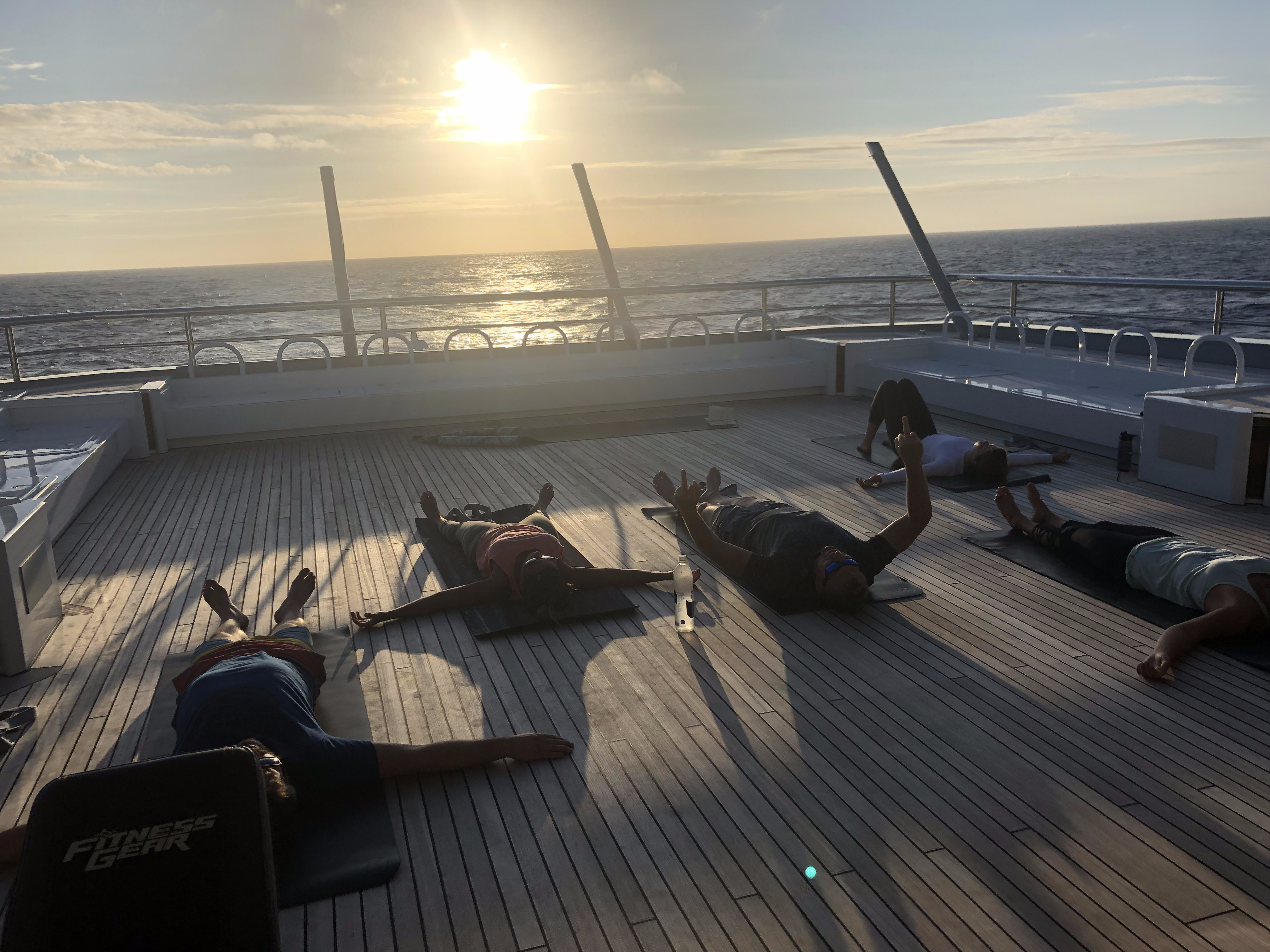 Shelby Tate leading a class on deck at sunset